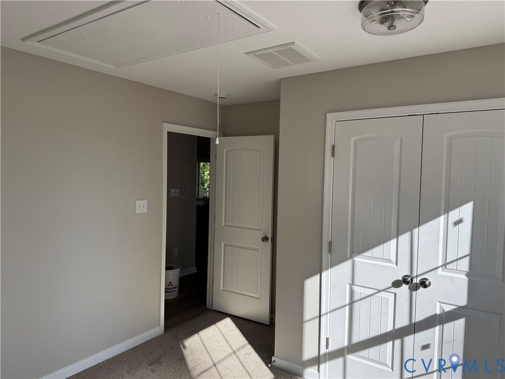 7735 Jefferson Highway, Cedar Hill Park, Mineral, VA 23117 Neutral wall paint, ceiling-mounted light fixture, white interior doors, and a ceiling access panel