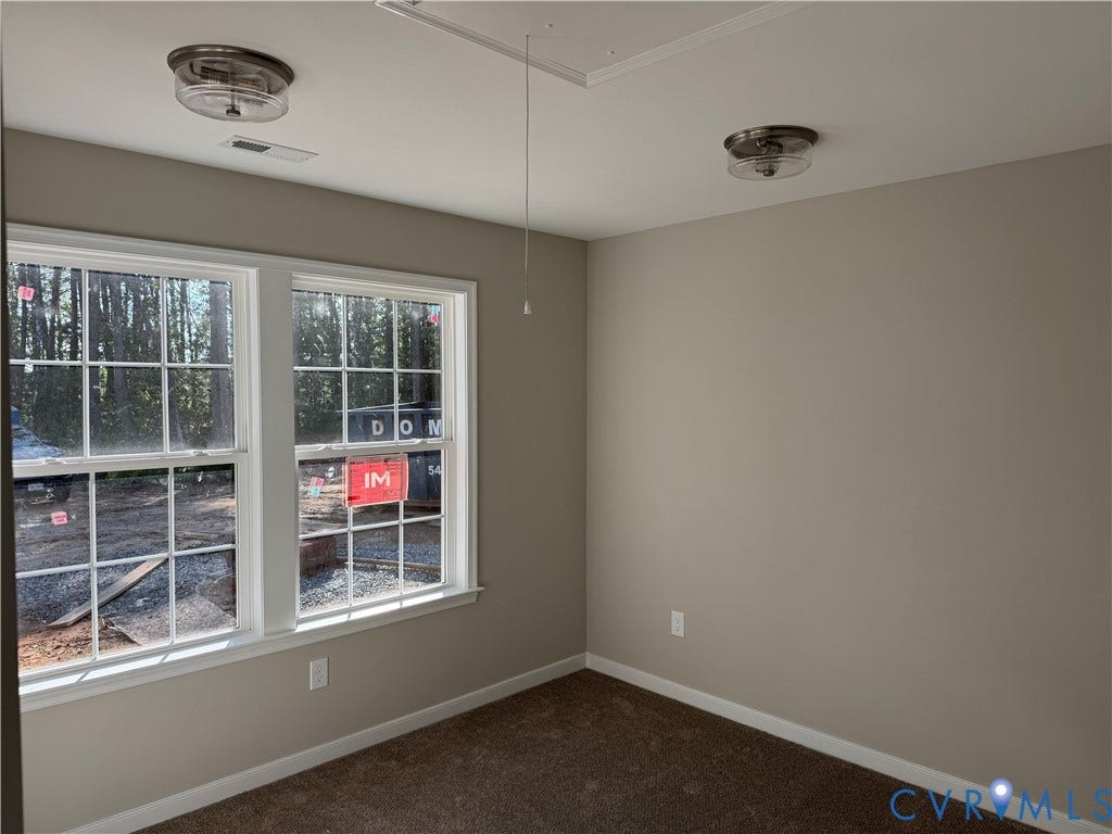 7735 Jefferson Highway, Cedar Hill Park, Mineral, VA 23117 Neutral wall color with two flush-mount ceiling lights, carpeted flooring, and two paneled windows