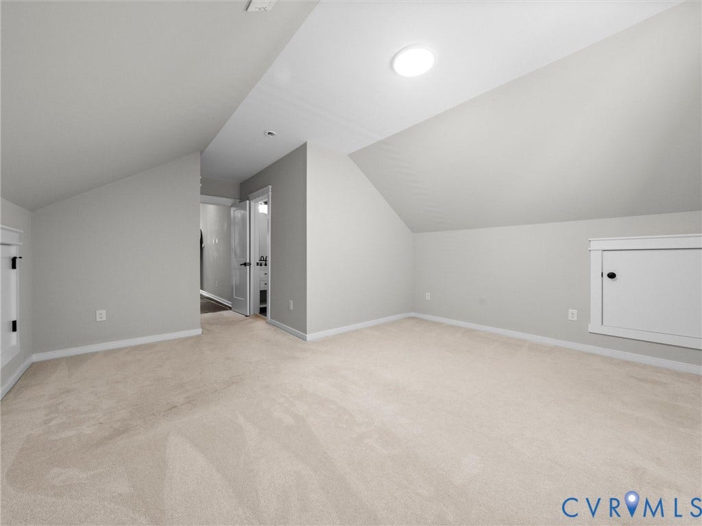Carpeted room featuring a white ceiling, light gray walls, and a circular ceiling light fixture