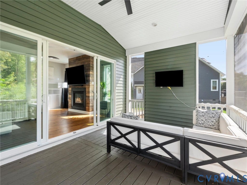 Screened porch with painted wood flooring, slatted siding, and a white vaulted ceiling