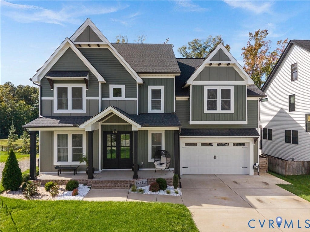 Craftsman-style exterior with gabled roof lines and dark green siding