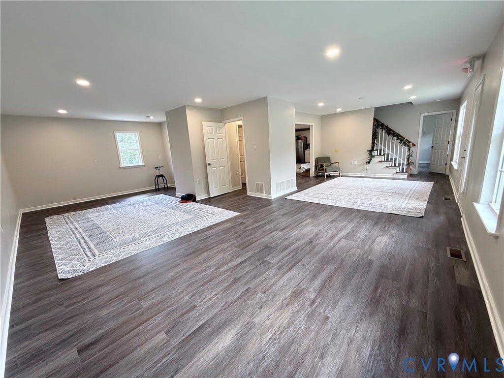 2091 Anderson Highway, Powhatan, VA 23139 Recessed ceiling lighting, wood-finish flooring, staircase with white risers and handrail, multiple windows, and light neutral wall paint