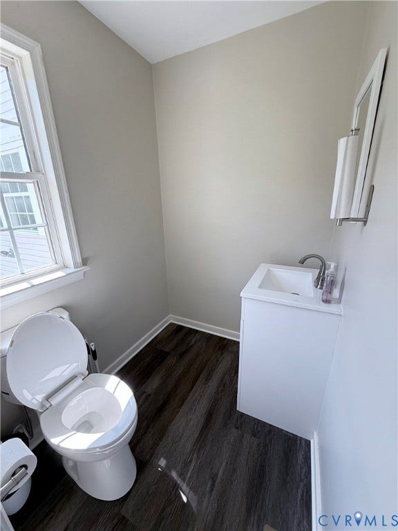 2091 Anderson Highway, Powhatan, VA 23139 Wood-finish flooring, white vanity with integrated sink, modern faucet, framed wall mirror, and neutral wall paint
