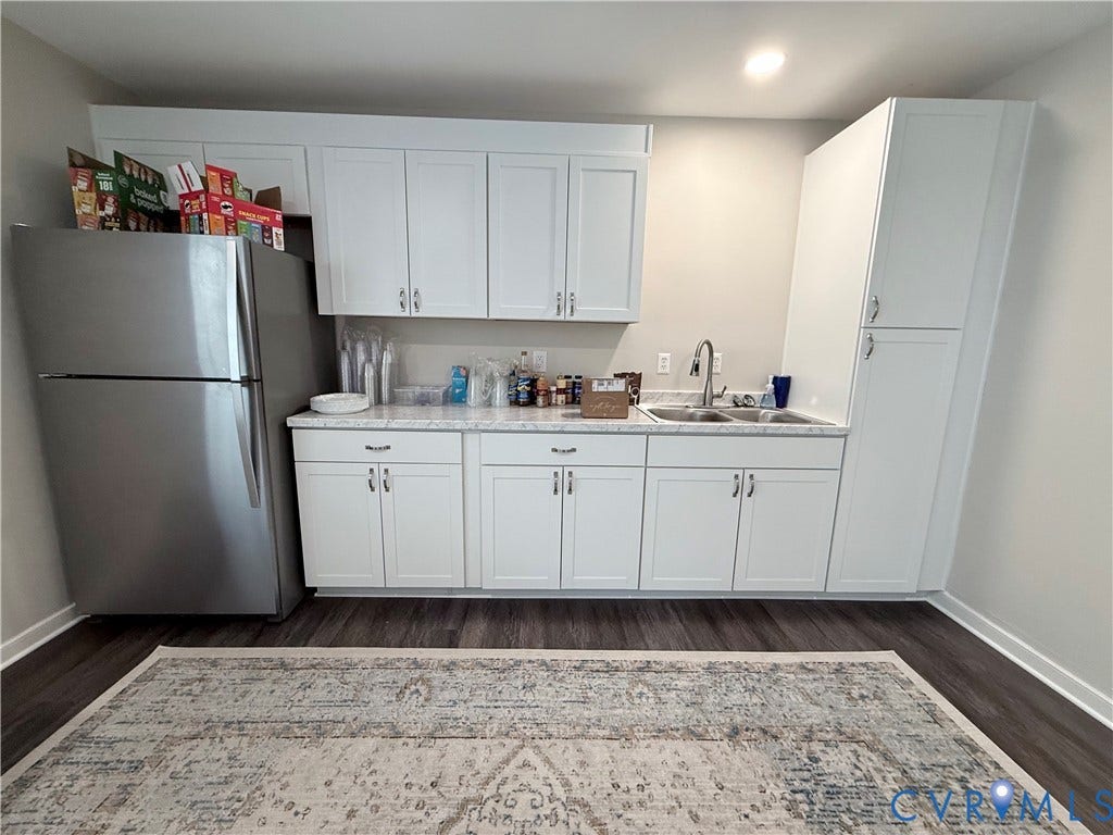 2091 Anderson Highway, Powhatan, VA 23139 Full white cabinetry with brushed nickel hardware, light-toned countertops, stainless steel refrigerator, and wood-finish flooring
