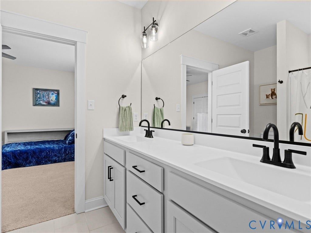 3719 Bellstone Drive, Midlothian, VA 23112 Dual sink vanity with matte black fixtures and light gray cabinetry
