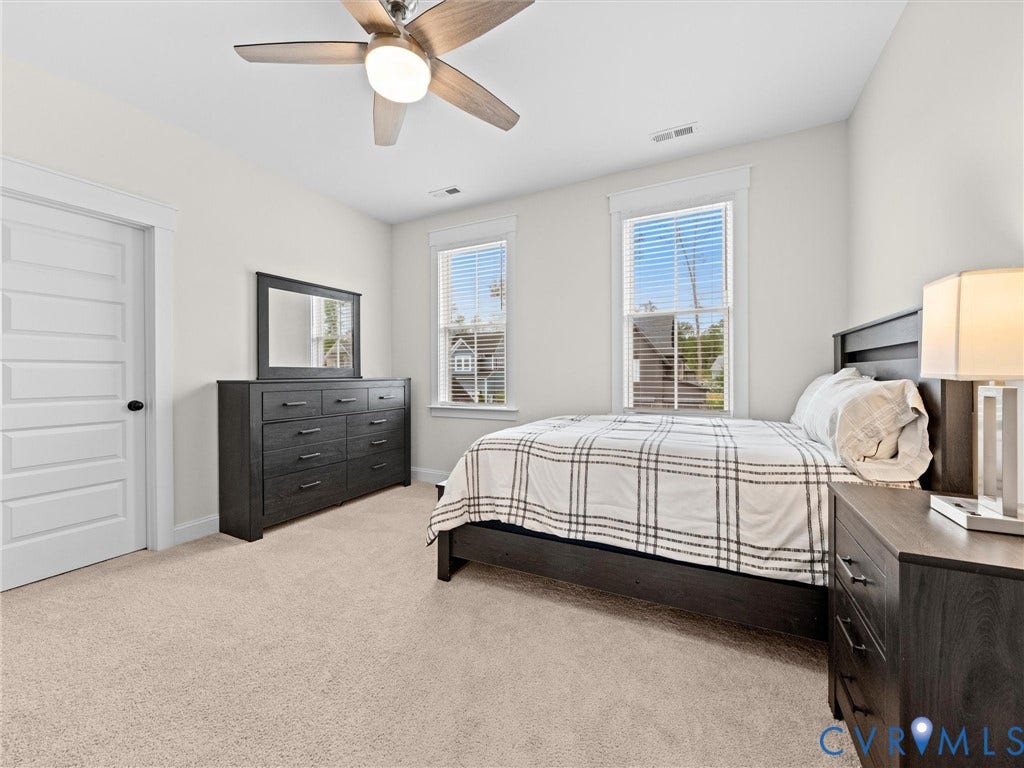 3719 Bellstone Drive, Midlothian, VA 23112 Carpeted flooring, two windows with blinds, a ceiling fan with integrated lighting, and a paneled interior door