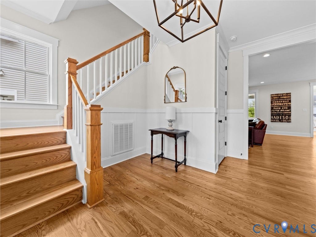 3719 Bellstone Drive, Midlothian, VA 23112 Hardwood flooring, wood staircase with white risers, white wainscoting, and a geometric chandelier
