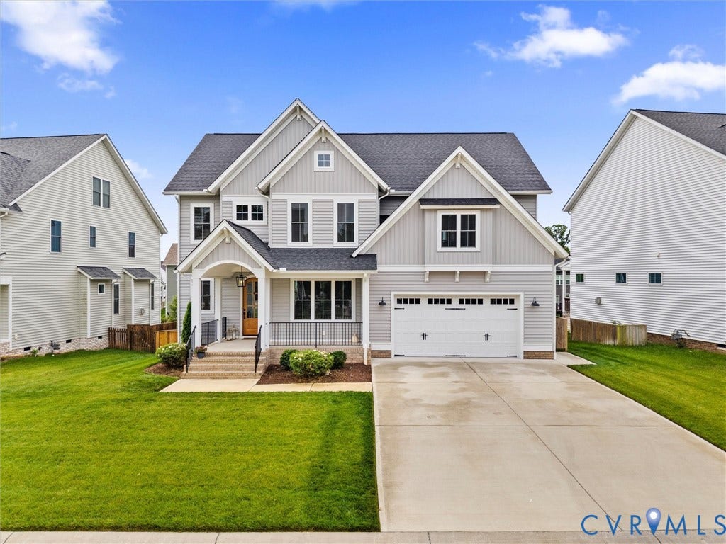 3719 Bellstone Drive, Midlothian, VA 23112 Contemporary home featuring light gray siding, a prominent front gable, an attached two-car garage, an arched entry porch, and a concrete driveway