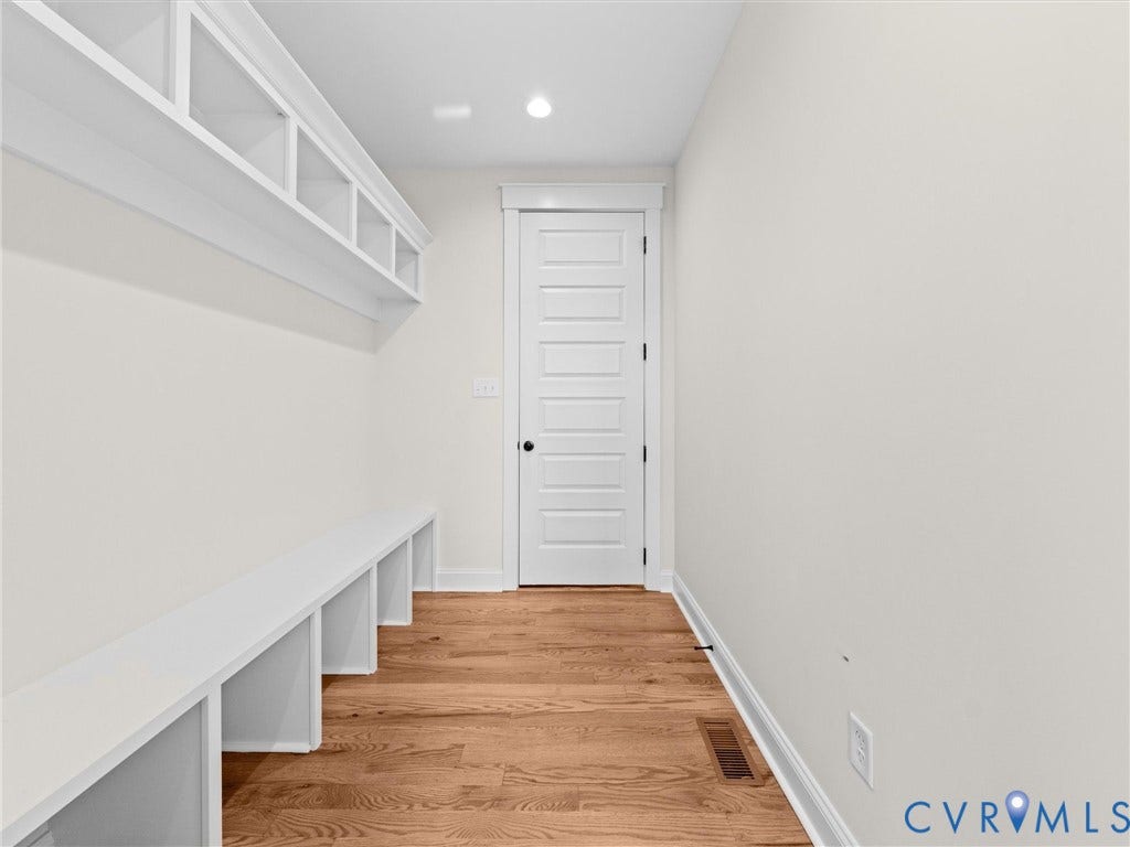 3719 Bellstone Drive, Midlothian, VA 23112 Built-in storage solutions featuring open shelving and bench seating, complemented by wood-finish flooring
