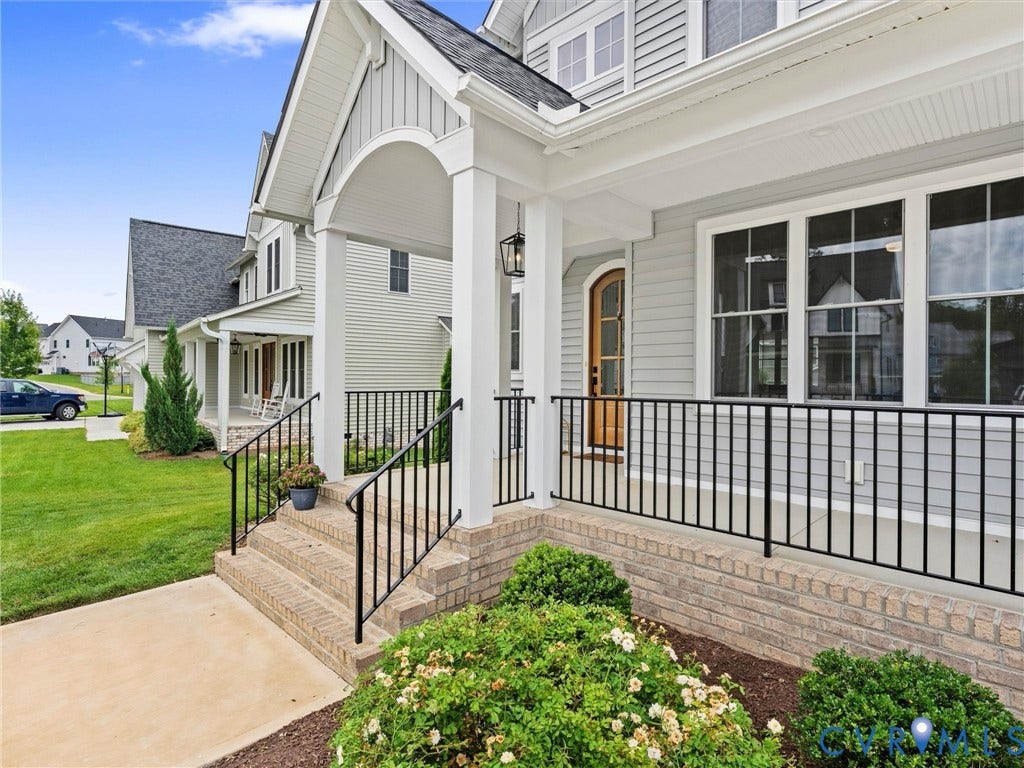 3719 Bellstone Drive, Midlothian, VA 23112 Front porch with a brick foundation, black metal railings, and a wood-finish front door