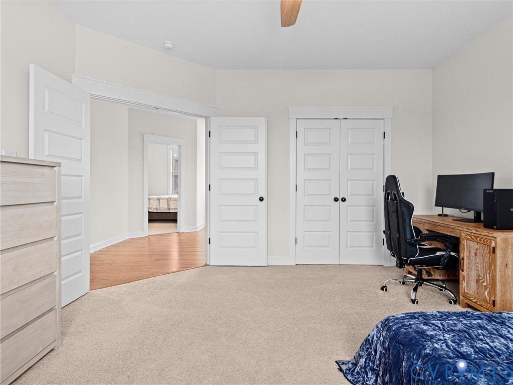 3719 Bellstone Drive, Midlothian, VA 23112 Plush carpeting with a ceiling fan, five-panel interior doors, and a wood-finish desk