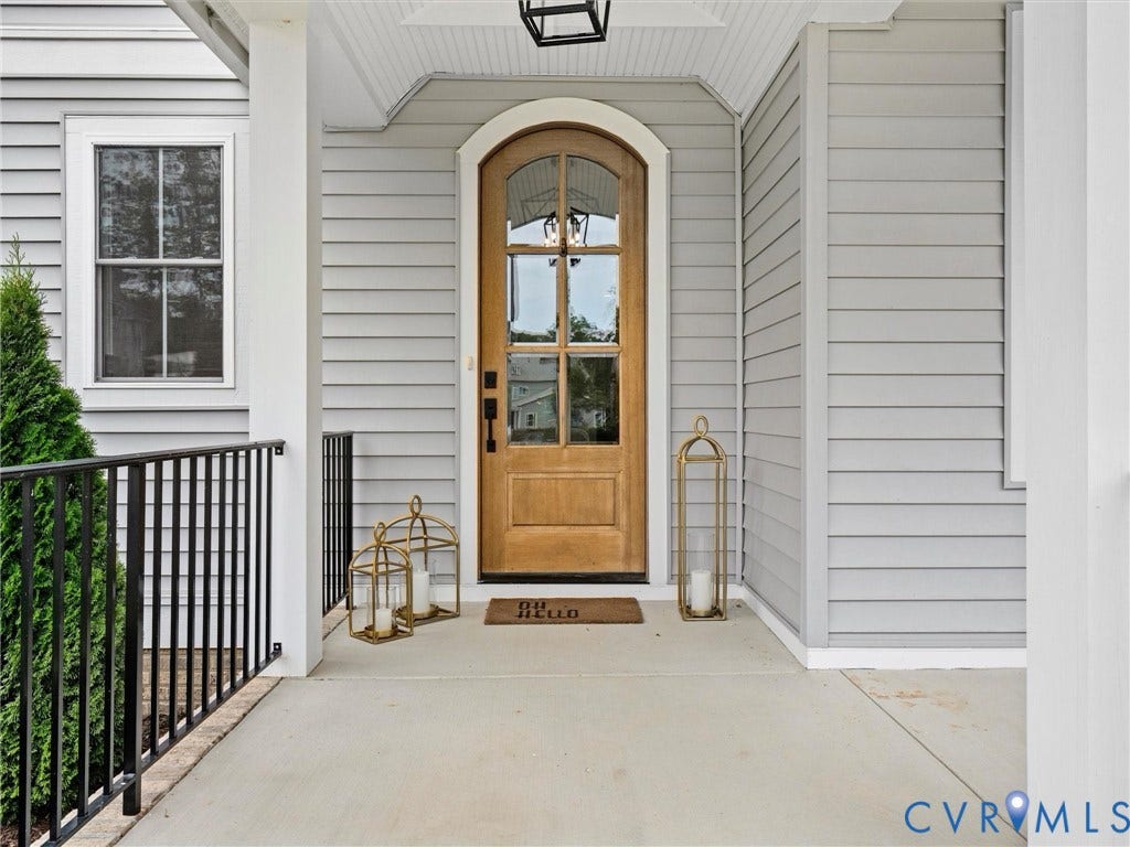 3719 Bellstone Drive, Midlothian, VA 23112 Arched wood-finish entry door with glass panels, light gray siding, and a white trim window
