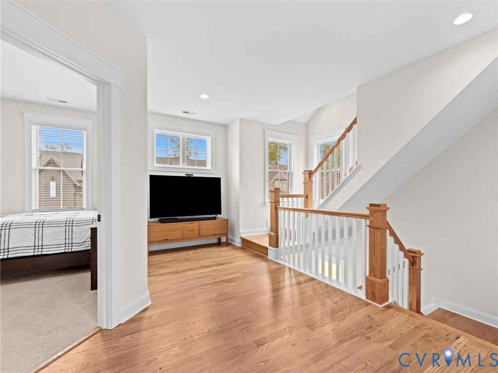 3719 Bellstone Drive, Midlothian, VA 23112 Hardwood flooring, recessed lighting, white trim, wood stair railing with white balusters, and multiple windows