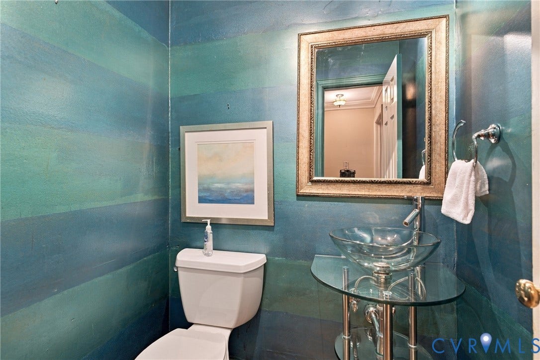 9015 Wood Sorrel Drive, Henrico, VA 23229 Glass vessel sink with chrome-finish hardware, glass pedestal stand, framed wall mirror, and dual-toned paint finish