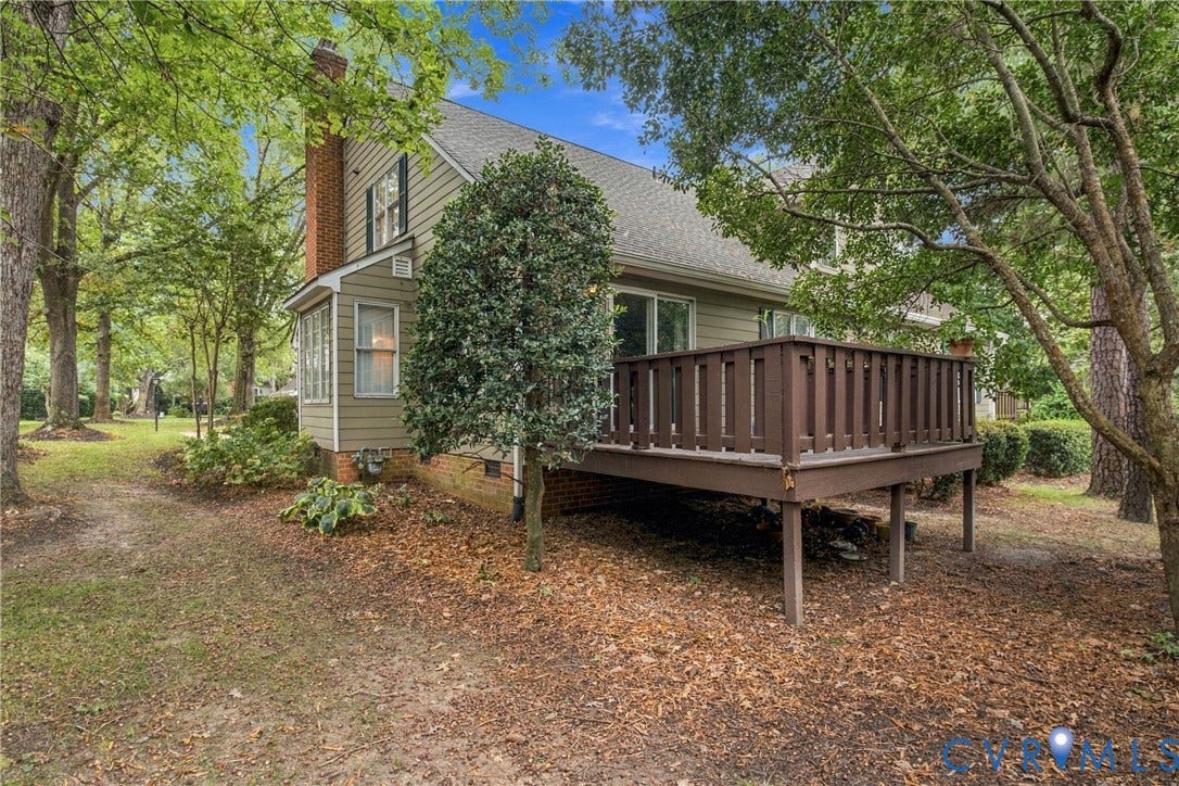 9015 Wood Sorrel Drive, Henrico, VA 23229 Exterior featuring horizontal siding, a raised wooden deck with railings, and an exposed brick chimney