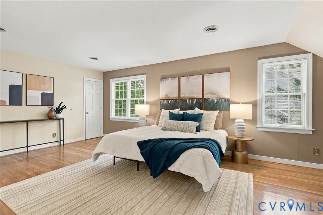 9015 Wood Sorrel Drive, Henrico, VA 23229 Spacious room featuring wood-finish flooring, two multi-pane windows with white trim, and recessed lighting