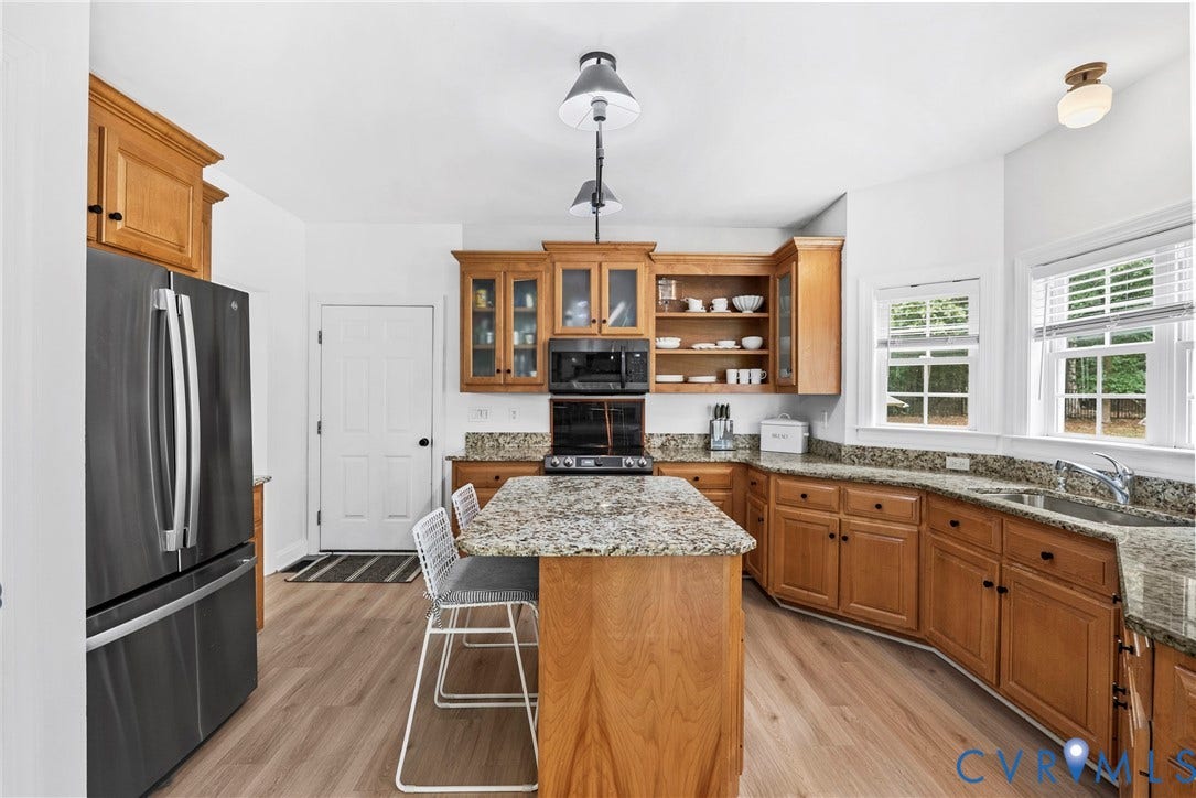 8406 Chandon Court, Chesterfield, VA 23838 Kitchen featuring an island with seating, ample wood cabinetry, granite countertops, modern stainless steel appliances, and wood-finish flooring