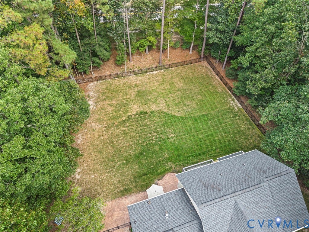 8406 Chandon Court, Chesterfield, VA 23838 Expansive backyard with a manicured lawn, established perimeter fencing, and mature trees