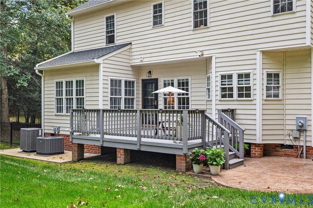 8406 Chandon Court, Chesterfield, VA 23838 Exterior featuring light-colored siding, a multi-level deck, and a stamped concrete patio