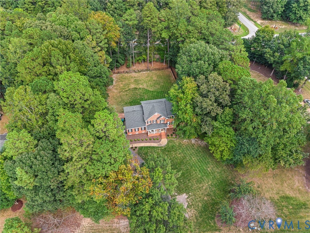 8406 Chandon Court, Chesterfield, VA 23838 Brick residence with a dark-pitched roof, surrounded by mature trees and manicured lawns