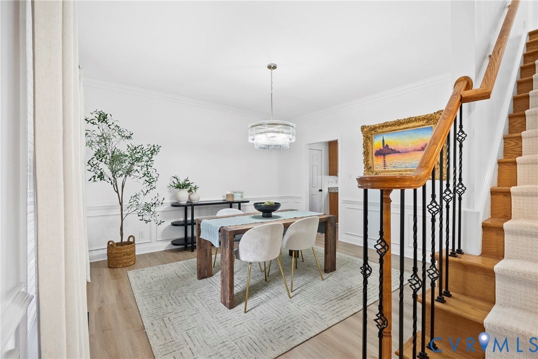 8406 Chandon Court, Chesterfield, VA 23838 Wood-finish flooring, staircase with wrought iron balusters, crown molding, chair rail molding, and a contemporary chandelier