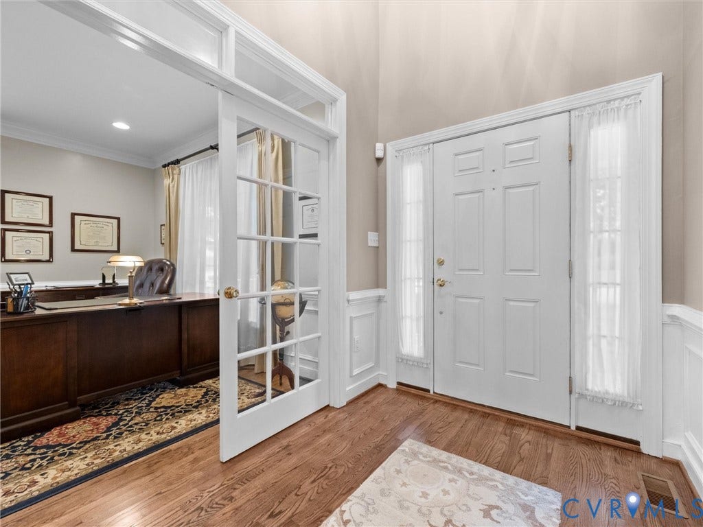 14779 Rolling Spring Drive, Charter Colony, Midlothian, VA 23114 A light-filled two-story foyer with classic millwork and hardwood floors, complemented by a private home office behind French doors.