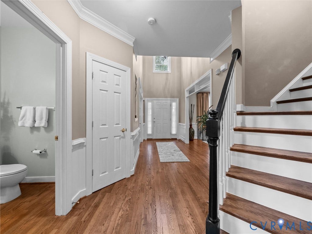 14779 Rolling Spring Drive, Charter Colony, Midlothian, VA 23114 Timeless details at every turngleaming hardwoods, a beautifully crafted staircase and classic millwork create a warm, polished transition through the heart of the home
