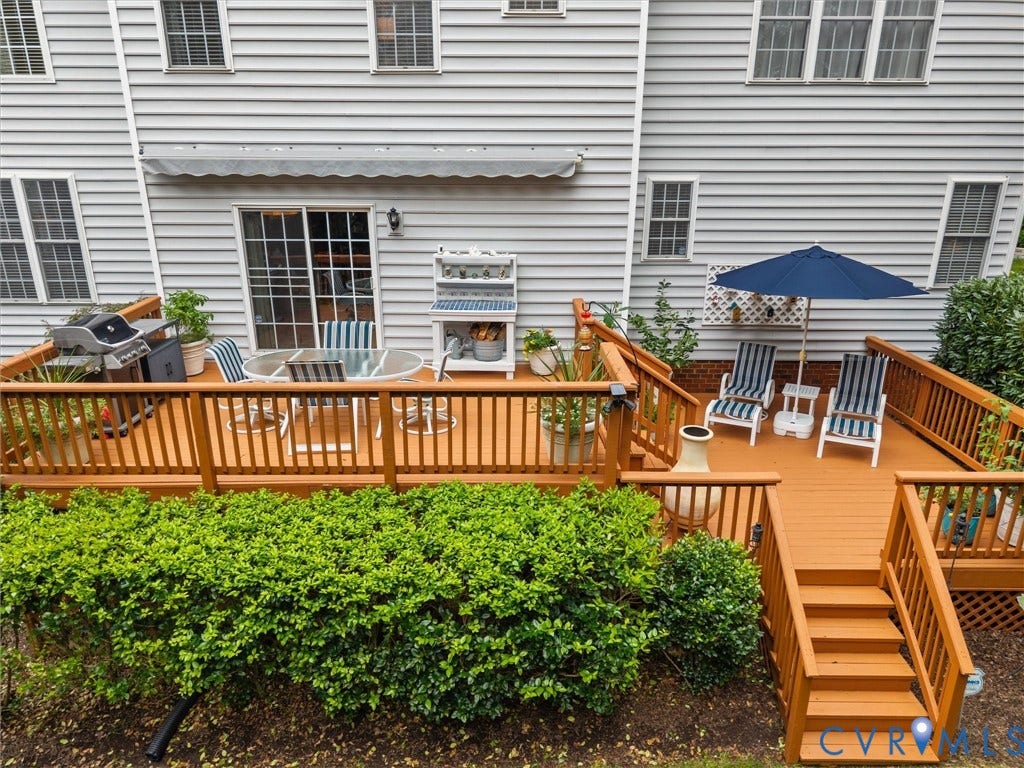 14779 Rolling Spring Drive, Charter Colony, Midlothian, VA 23114 Outdoor living at its bestan expansive multi-level deck creates distinct spaces for dining, grilling, entertaining and relaxing, all overlooking the beautifully landscaped backyard. Thoughtfully designed to extend the homes living space outdoors, with a retractable awning providing welcome shade when desired