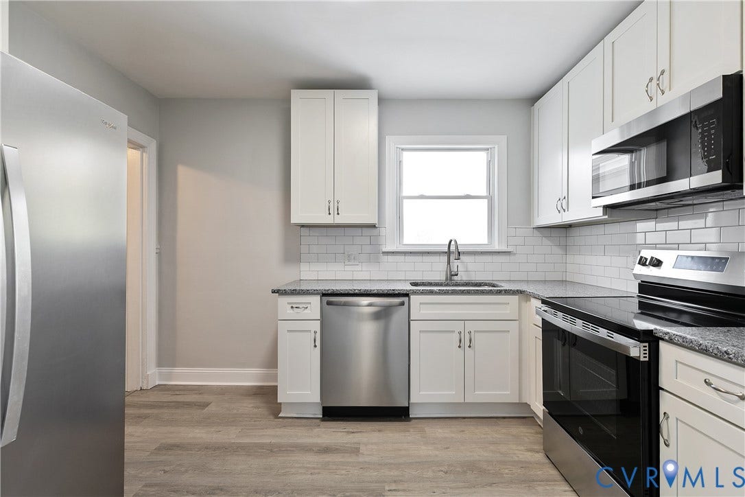 1305 Overlook Street, Richmond, VA 23224 Kitchen featuring white cabinetry, stainless steel appliances, granite-style countertops, white subway tile backsplash, and wood-finish flooring