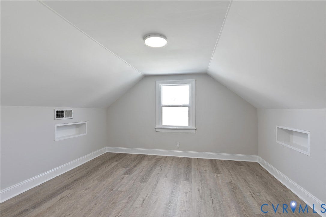1305 Overlook Street, Richmond, VA 23224 Sloped ceilings, wood-finish flooring, recessed wall shelving, ceiling-mounted light fixture, and a white-framed window