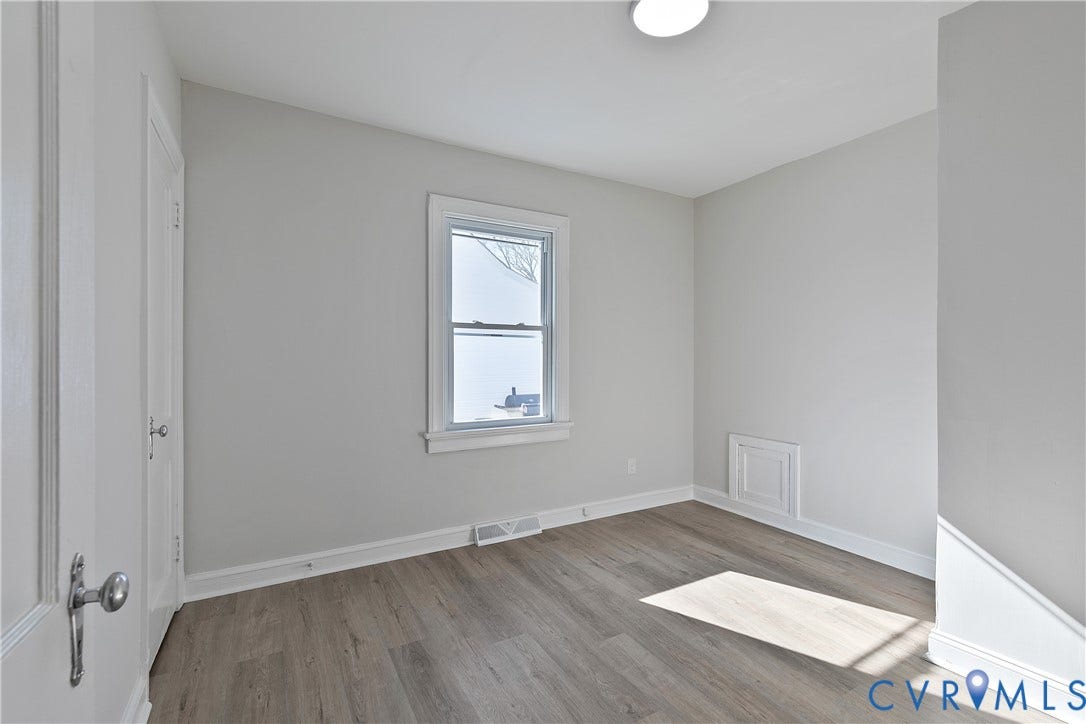 1305 Overlook Street, Richmond, VA 23224 Room featuring wood-finish flooring, a single window, a flush-mount ceiling light, and white trim