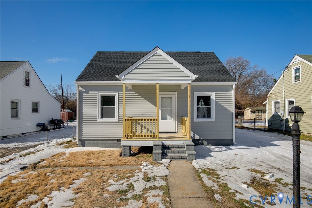 1305 Overlook Street, Richmond, VA 23224 Light-gray siding exterior with a dark shingle roof, a covered porch with a wood railing, and concrete entry steps