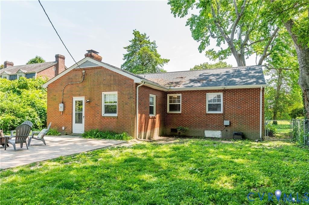 2304 Buckingham Avenue, Henrico, VA 23228 Red brick exterior featuring multiple windows and a white door