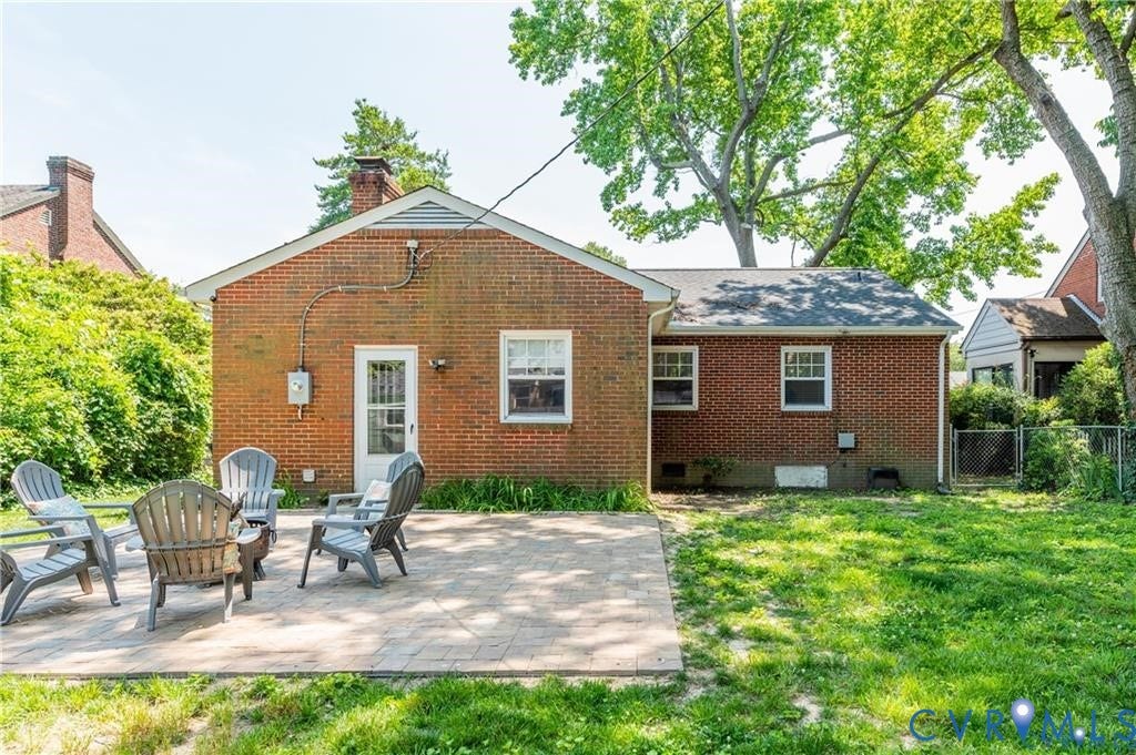 2304 Buckingham Avenue, Henrico, VA 23228 Brick exterior with a gabled roofline, multiple windows, and a paved patio