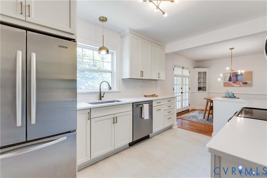 2304 Buckingham Avenue, Henrico, VA 23228 Stainless steel appliances, white cabinetry with dark hardware, a single basin sink with a gooseneck faucet, light-toned flooring, and a white countertop