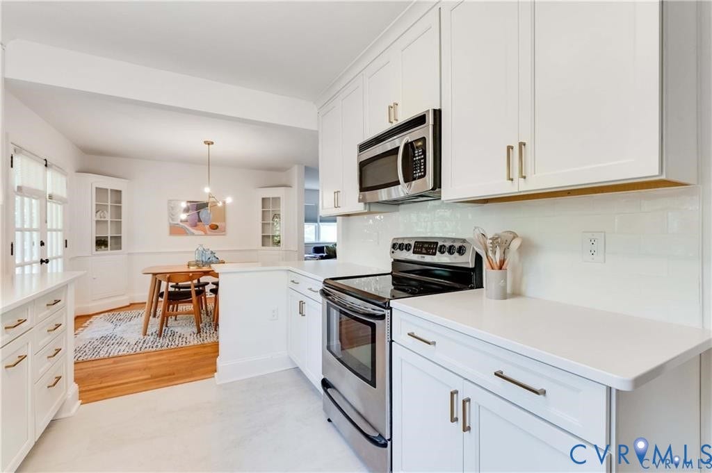 2304 Buckingham Avenue, Henrico, VA 23228 Kitchen featuring white shaker cabinetry, stainless steel appliances, white subway tile backsplash, and light countertops