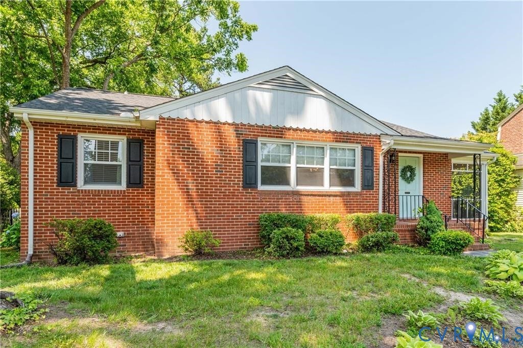 2304 Buckingham Avenue, Henrico, VA 23228 Brick exterior with black shutters, mature landscaping, and a covered front entry with a light blue door