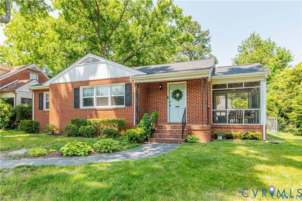 2304 Buckingham Avenue, Henrico, VA 23228 Brick exterior, screened porch, light blue entry door, black window shutters, and a stone walkway