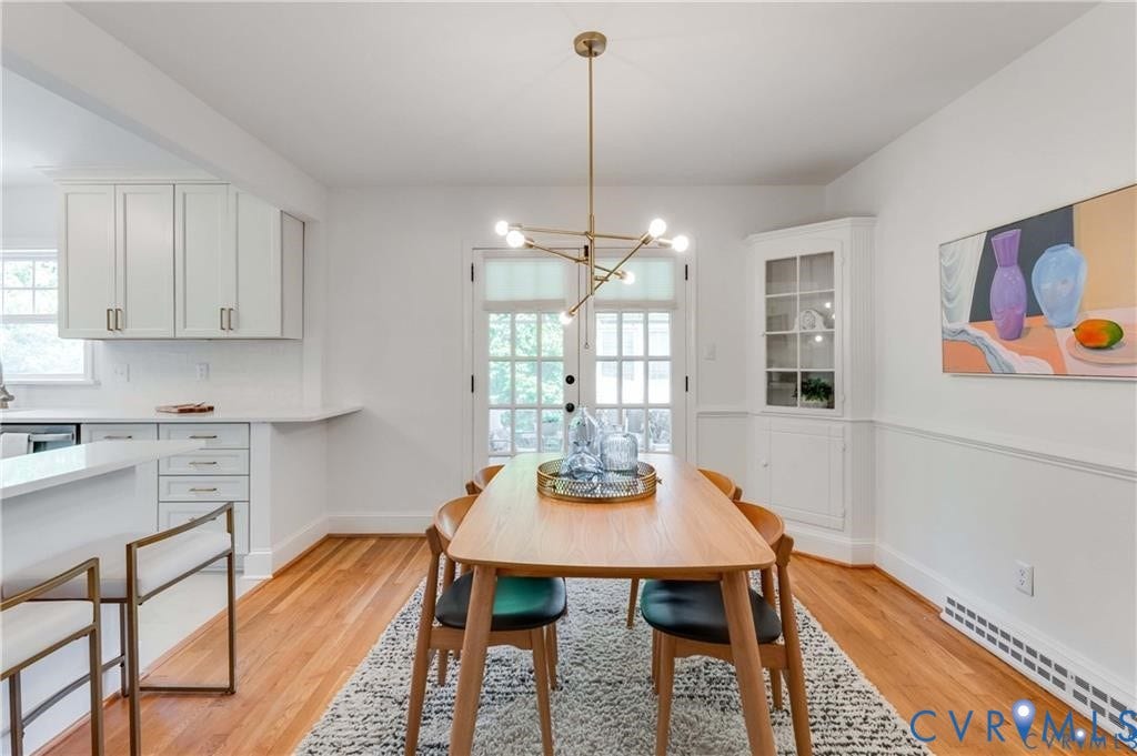 2304 Buckingham Avenue, Henrico, VA 23228 Hardwood flooring, white shaker-style cabinetry, white countertops, built-in corner cabinet, and a contemporary linear chandelier