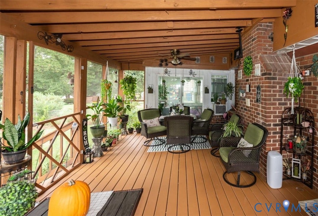 5510 Alberta Road, Stanwick, Midlothian, VA 23832 Screened porch with wood-finish flooring, wood beam ceiling, brick accent wall, and a ceiling fan