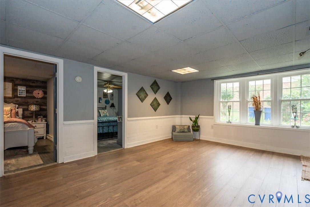 5510 Alberta Road, Stanwick, Midlothian, VA 23832 Wood-finish flooring, white chair rail, three-panel window, overhead fluorescent lighting, and two doorway entrances