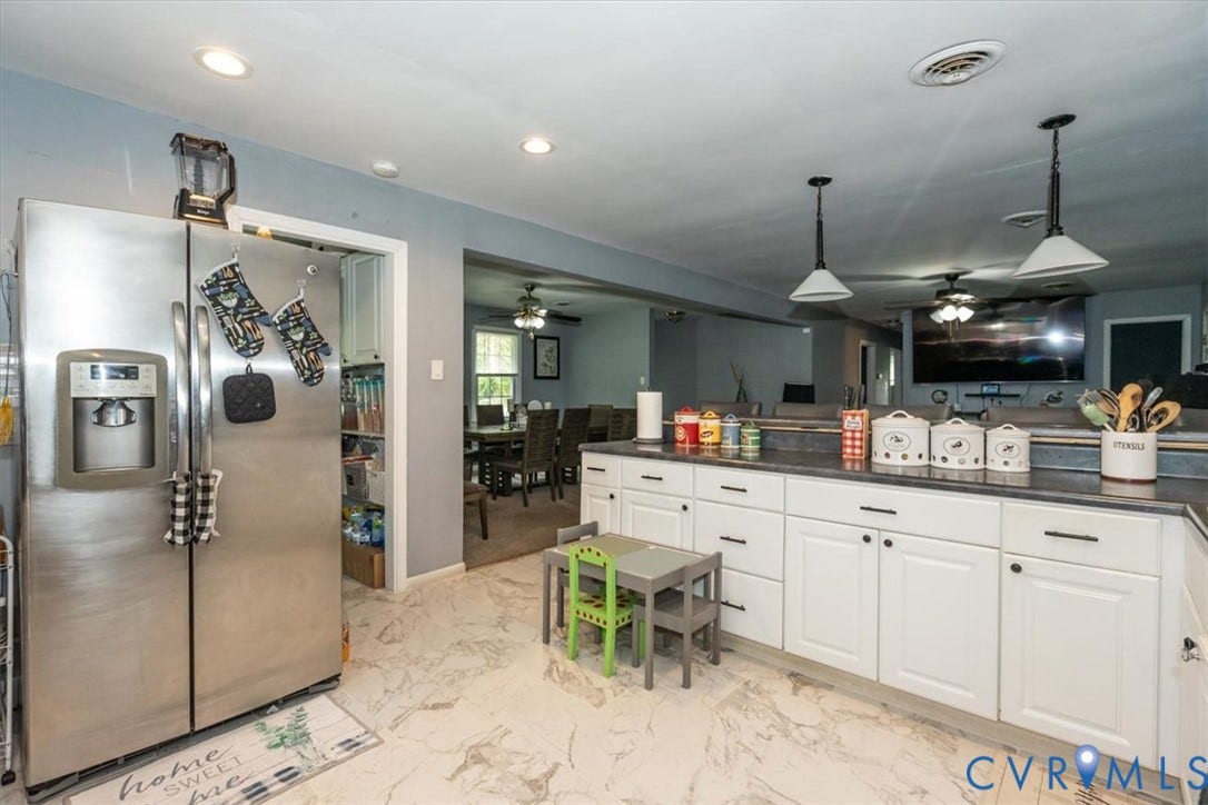 5510 Alberta Road, Stanwick, Midlothian, VA 23832 Stainless steel side-by-side refrigerator, white cabinetry with dark hardware, dark countertops, recessed lighting, and pendant lighting