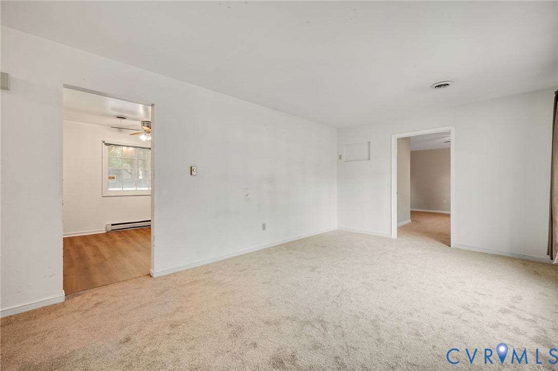 Neutral tone walls and carpeting throughout the main space