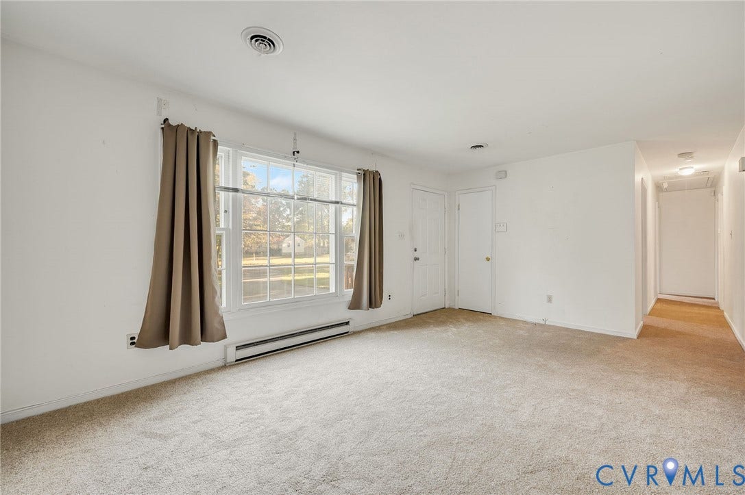 Broadloom carpeting and a white door with paneling