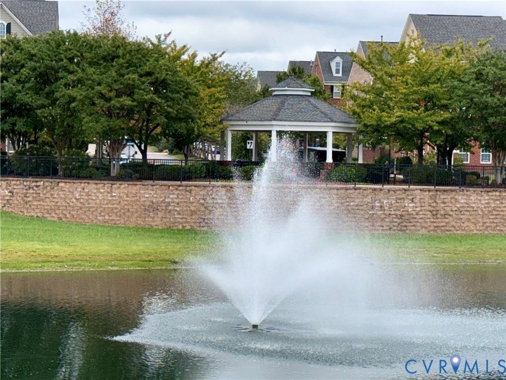 3900 Liesfeld Place, Glen Allen, VA 23060 Pond with a central fountain, surrounded by a brick retaining wall and mature landscaping