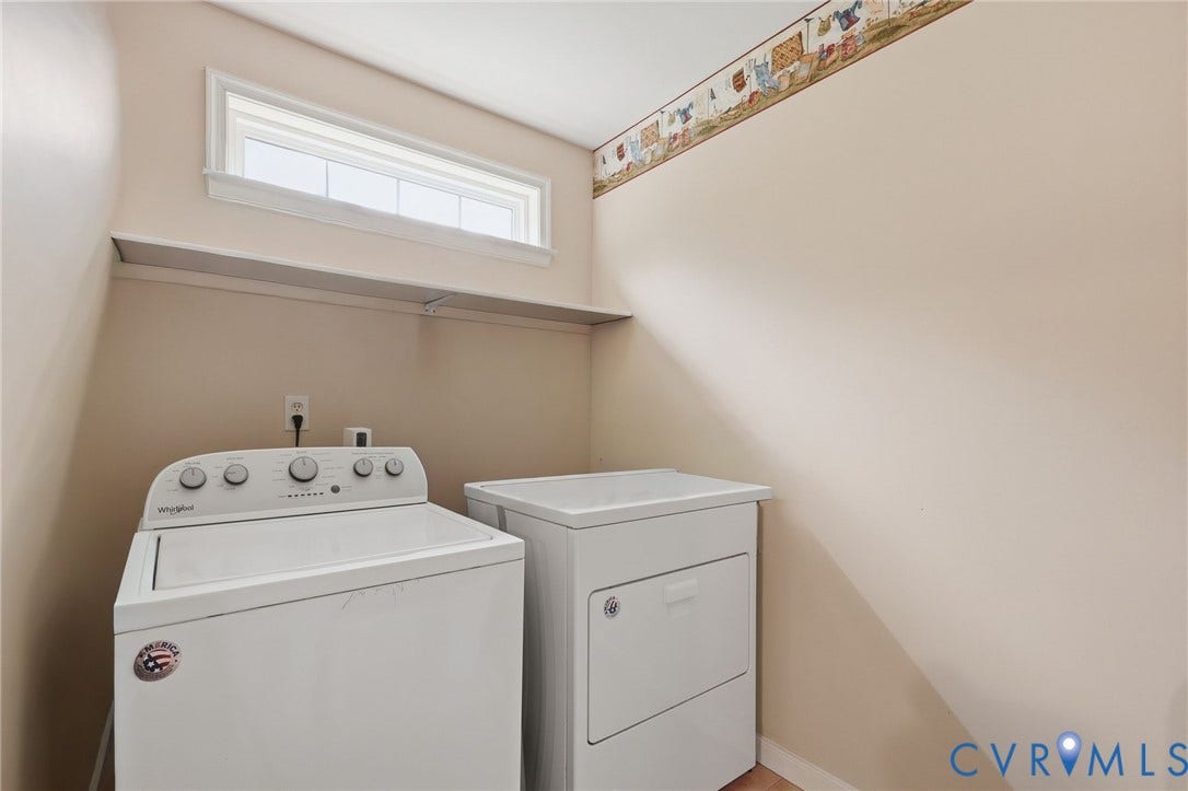 Laundry area featuring a top-load washing machine, front-load dryer, and an upper shelf