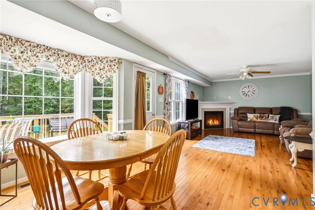 Hardwood flooring, white trim, recessed lighting, ceiling fan, and fireplace with mantel