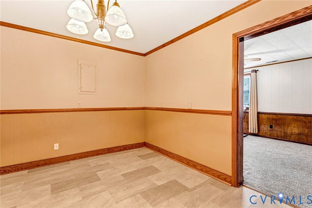 Room featuring wood-finish flooring and a decorative chandelier