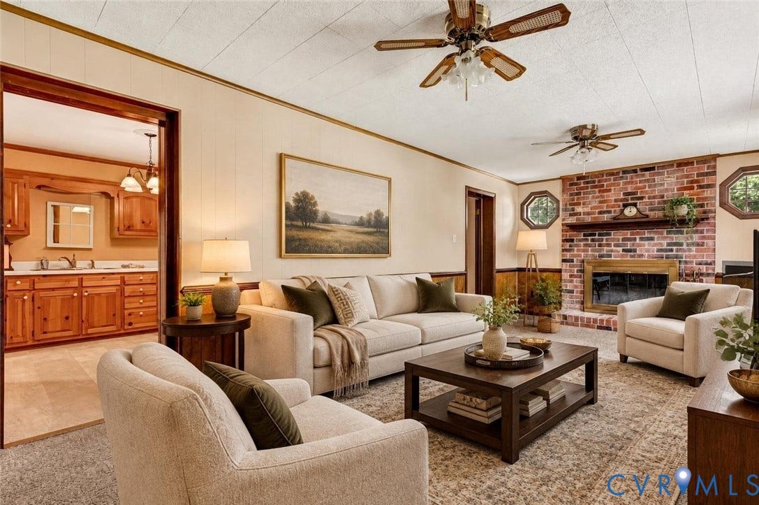 Brick fireplace with a wood mantle, two ceiling fans, and wood-paneled wainscoting