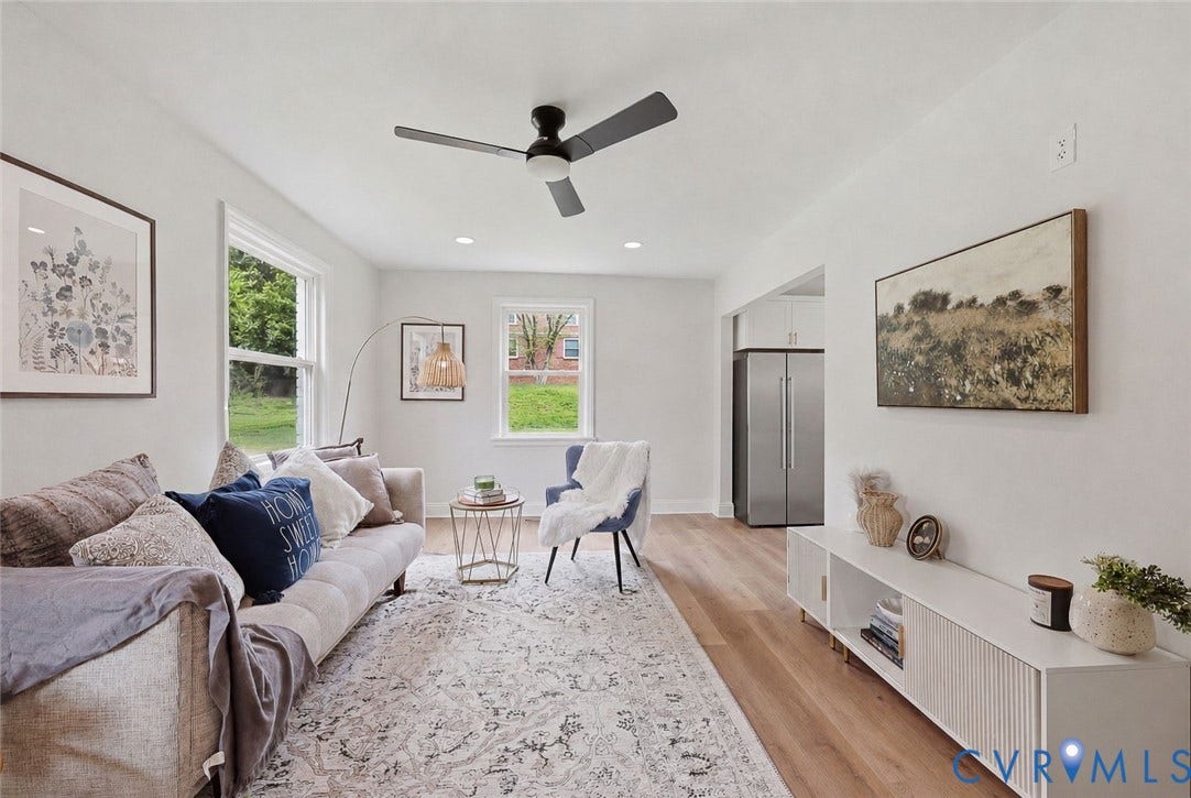 Recessed lighting, wood-finish flooring, white walls, and a ceiling fan with integrated lighting